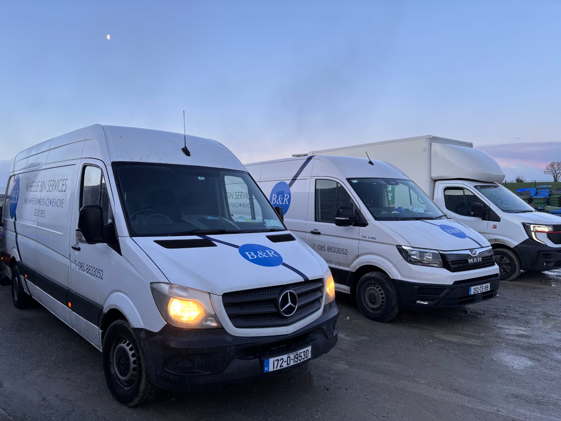 Three RBM service vans lined up in the yard at dusk